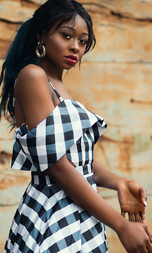Model in a black and white plaid dress